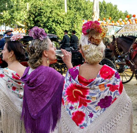 Seville, Spain - May 09, 2019 : Women wearing flamenco dress at the April Fair (Feria de Abril), Seville Fair (Feria de Sevilla), Andalusia, Spainのeditorial素材