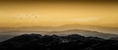 Amazing mountain landscape with fog and vivid sunset. Outdoor travel background. Central system. Spain. Europeの写真素材