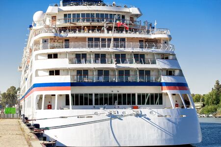 Luxury cruise ship docked in port. Front view of white passenger vessel.の写真素材