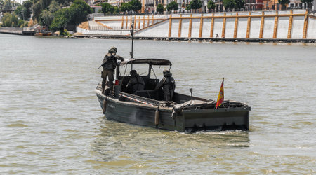 Armed soldiers aboard light boat during military operation in the city river.のeditorial素材