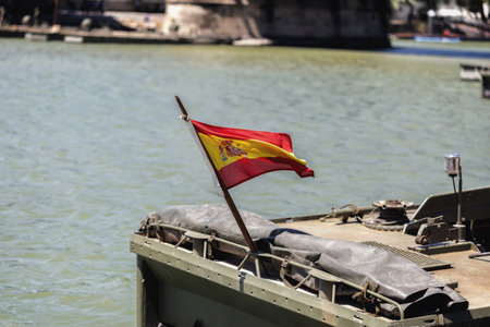 Seville, Spain - May 30, 2019: Spanish flag waving over boat during display of Spanish Armed Forces Day in Seville, Spainのeditorial素材