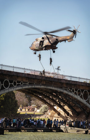 Seville, Spain - May 30, 2019: Military helicopter flying over the Guadalquivir river during display of Spanish Armed Forces Day in Seville, Spainのeditorial素材