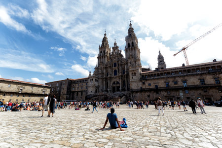 Santiago de Compostela, Spain - August 20 2019: Pilgrims and tourists in the Plaza del Obradoiro.. The Plaza del Obradoiro is the largest of its kind in the whole of Galicia and it becomes the center point for the 25th July Saint James day.のeditorial素材