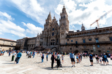 Santiago de Compostela, Spain - August 20 2019: Pilgrims and tourists in the Plaza del Obradoiro.. The Plaza del Obradoiro is the largest of its kind in the whole of Galicia and it becomes the center point for the 25th July Saint James day.のeditorial素材