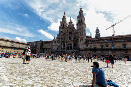 Santiago de Compostela, Spain - August 20 2019: Pilgrims and tourists in the Plaza del Obradoiro.. The Plaza del Obradoiro is the largest of its kind in the whole of Galicia and it becomes the center point for the 25th July Saint James day.のeditorial素材