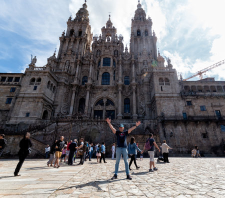 Santiago de Compostela, Spain - August 20 2019: Pilgrims and tourists in the Plaza del Obradoiro.. The Plaza del Obradoiro is the largest of its kind in the whole of Galicia and it becomes the center point for the 25th July Saint James day.のeditorial素材