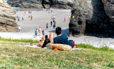 Ribadeo, Spain - August 21 2019: Cathedrals beach. Designated a Natural Monument, is one of the most famous beaches in Galicia. It is known around the world for its rocky formations carved by the wind and sea.のeditorial素材