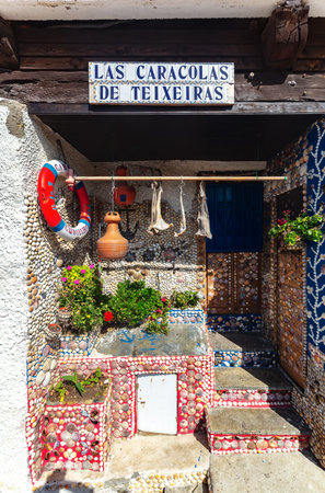 Cudillero, Spain - August 23 2019: Nice and colorful house decorated with seashells in the traditional and beautiful village in Cudillero. Cudillero is a tourist destination and also known for its fishing industry located in Asturias, Spain.のeditorial素材
