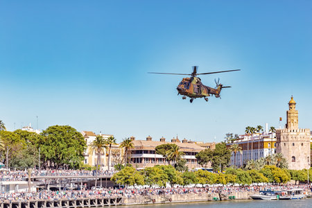 Seville, Spain - May 31, 2019: Military helicopter flying over the Guadalquivir river during display of Spanish Armed Forces Day in Seville, Spainのeditorial素材
