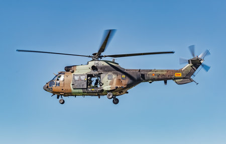Seville, Spain - May 31, 2019: Military helicopter flying over the Guadalquivir river during display of Spanish Armed Forces Day in Seville, Spainのeditorial素材