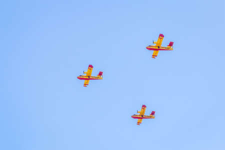 Modern armed military transport planes flys in formation through the sky.の写真素材
