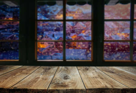 Empty wooden table background with blurred christmas scene ..の写真素材