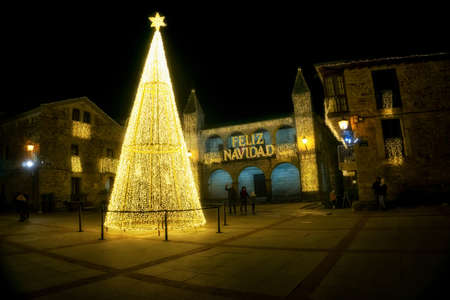 Puebla de Sanabria, Spain - December 06, 2021: People walking and enjoying the Christmas lights in...