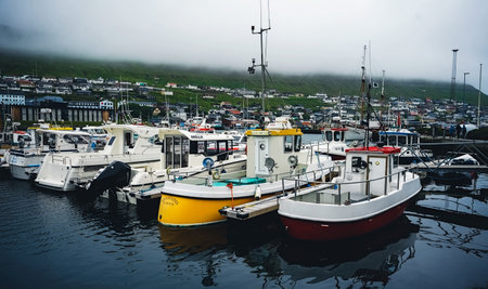 Klaksvik, Faroe Islands - July 19, 2019: Fishing and sailing boats in the harbor of Klaksvik. It is an important harbor with fishing industry, and a modern fishing-fleet. Klaksvik is located in Bordoy island (Nordoyar) Faroe Islands, Denmark, Europeのeditorial素材