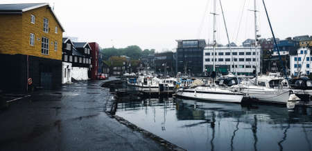 Torshawn, Faroe Islands - July 20, 2019: Colorful buildings and boats in Vestaravag harbor. Torshawn city is the capital and largest city of the Faroe Islands. Danish.のeditorial素材