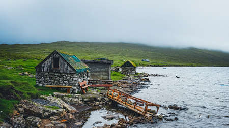 Old traditional house near the sea on the island of Mykines in the Faroe Islandsの写真素材
