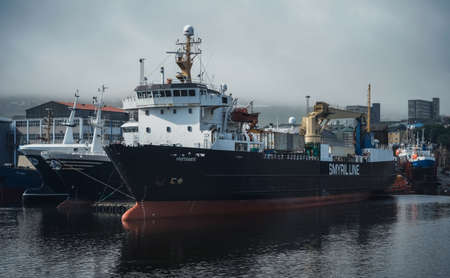 Torshavn, Faroe Islands - July 22, 2019: Container Cargo Ship in Torshavn marina harbor on Faroe islands. Torshavn Harbor located in the south eastern part of Streymoy is the largest and busiest port in the Faroe Islands.のeditorial素材