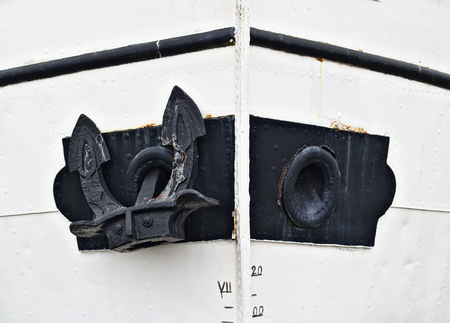 Big black anchor on a white hullの写真素材