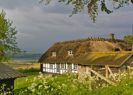 Lyo, Denmark - July 4th, 2012 - Traditional timber-framed thatched Danish farmhouse on the island of Lyo in the Balticのeditorial素材