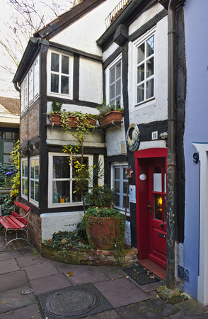 Bremen, Germany - November 23rd, 2017 - White timber-framed town house with red door in the historic Schnoor districtのeditorial素材