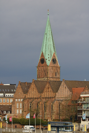 Bremen, Germany - November 23rd, 2017 - Historic St. Martin's church with tall spire and rain clouds in the backgroundのeditorial素材