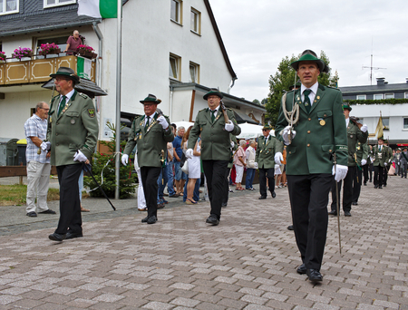 Usseln, Germany - July 30th, 2018 - Rifle club members parading in their traditional green uniforms at the marksmen's fairのeditorial素材