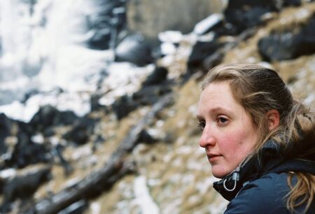 Young woman taking in the scenery during a hike up mountains.の写真素材