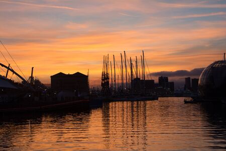 sundown in Genoa harbor in ancient portの写真素材