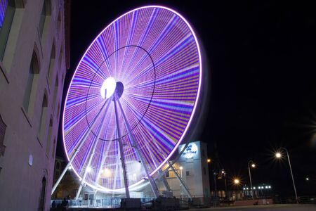 Panoramic wheel in the night. Colored modern ferris wheel tourist attractionのeditorial素材