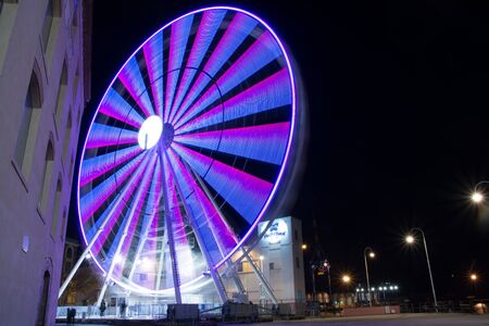 Panoramic wheel in the night. Colored modern ferris wheel tourist attractionのeditorial素材