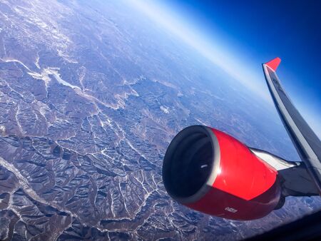 An aerial view from the airplane flying high above the ground. A look from the planeÂ´s window...