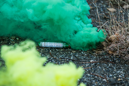 A picture of smoking smoke bomb. It releases the colorful smoke.