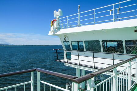 A detail part of a big sea ferry, the captainÂ´s bridge during the hot summer day.