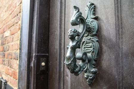 A detail of the old ornamental door handle. Nice example of the artificial detail on onld houses.