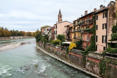 The cityscape of the ancient town Verona in Italy. You can see the river Adige with the houses by the riverbank.の写真素材