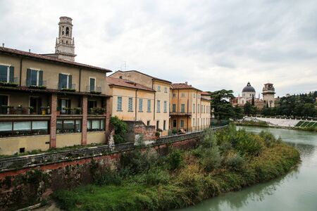 The cityscape of the ancient town Verona in Italy. You can see the river Adige with the houses by the riverbank.の写真素材