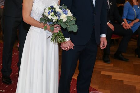 A detail picture from the wedding. The pair is holding their hands during the ceremony. A symbol of their love.の写真素材