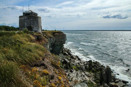 The Picture from the wild coast of Paldiski in Estonia. You can see the old military building from soviet era standing on the cliff.の写真素材