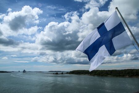 The Picture from a ferry between Sweden and Finland. The fiinnish flah is hanging on the back part of the ship.の写真素材