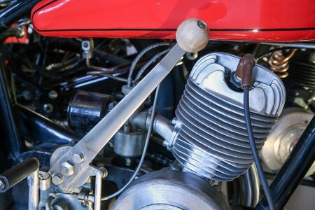 The detail of the old motorcycle with part of the frame, engine, fuel tank and a gear stick.の写真素材