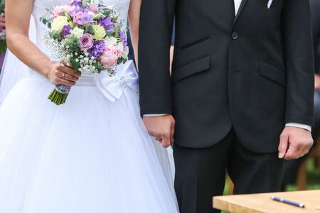 A detail picture from the wedding. The pair is holding their hands during the ceremony. A symbol of...