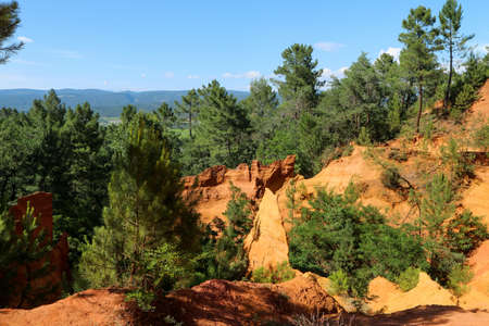 The nice yellow and red sandstone rocks by Roussillon in France. The nice natural sight and tourist attraction.の写真素材