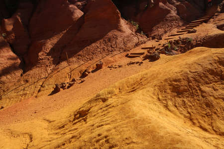 The nice yellow and red sandstone rocks by Roussillon in France. The nice natural sight and tourist attraction.の写真素材