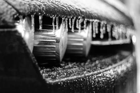 A detail of the frozen car covered by the black ice.の写真素材