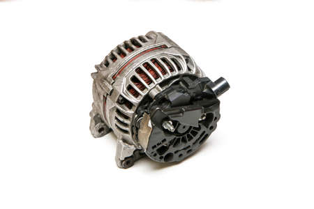 The old used and broken alternator from the motor vehicle isolated on a white background.