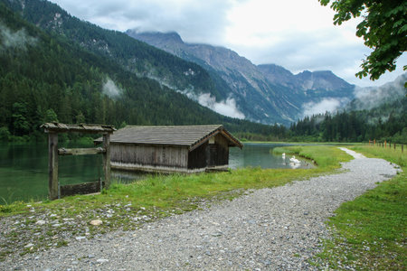 The glacier lake JÃ¤gersee in Austria in the Alps during the rainy and cloudy day. Travel...