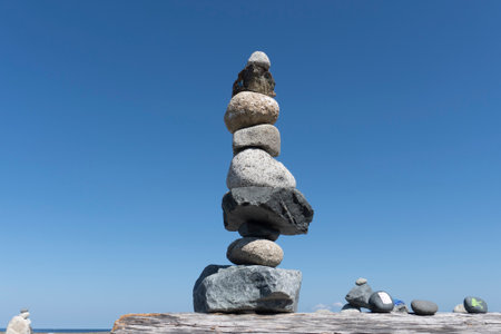 Pyramid of stones on a background of the sea and blue sky
