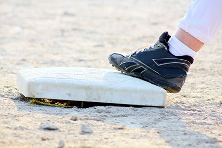 childs foot on baseの写真素材