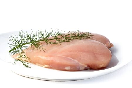 Raw Foods - Chicken breast with wild fennel isolated on white background.の写真素材