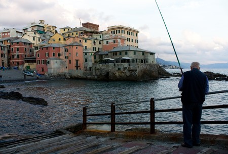 GENOA, OCTOBER 5, 2009: Silhouette of man fishing in the small district Boccadasse, October 5, 2010, Genoa, Italyのeditorial素材